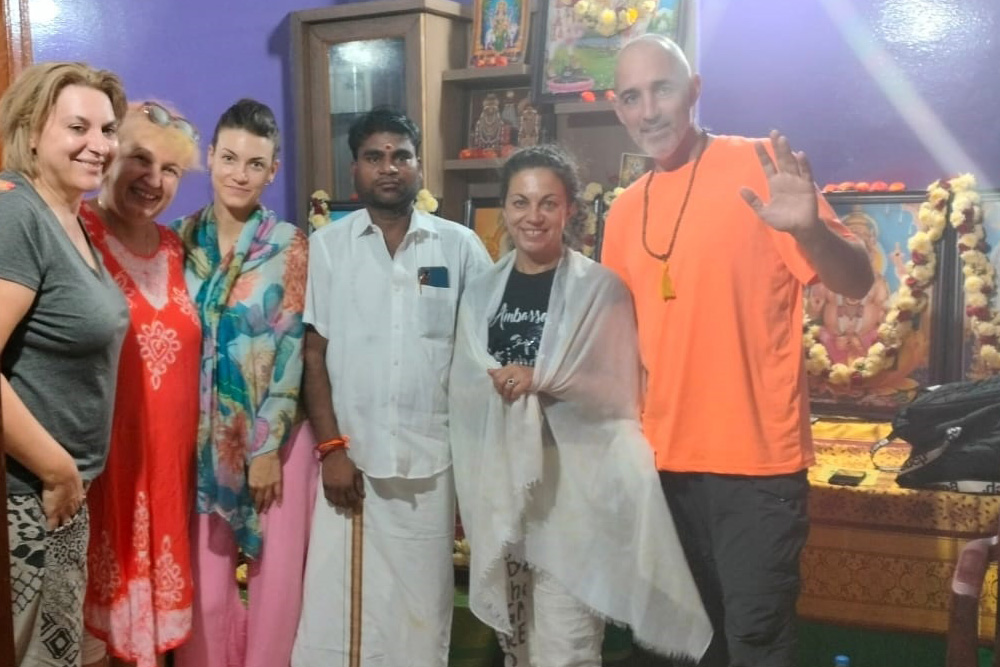 A Nadi reader explaining a palm leaf reading to a client